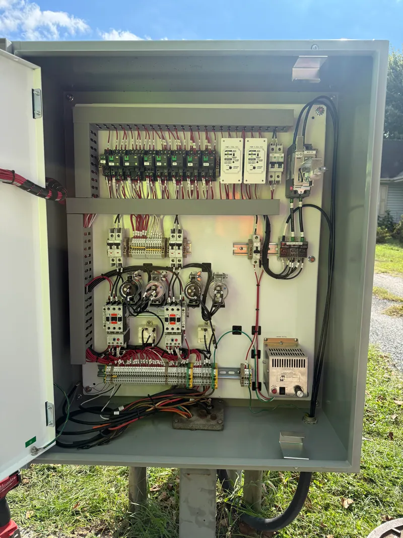 After: a new outdoor enclosure with an organized backplate — wire duct, breakers, contactors and terminal blocks